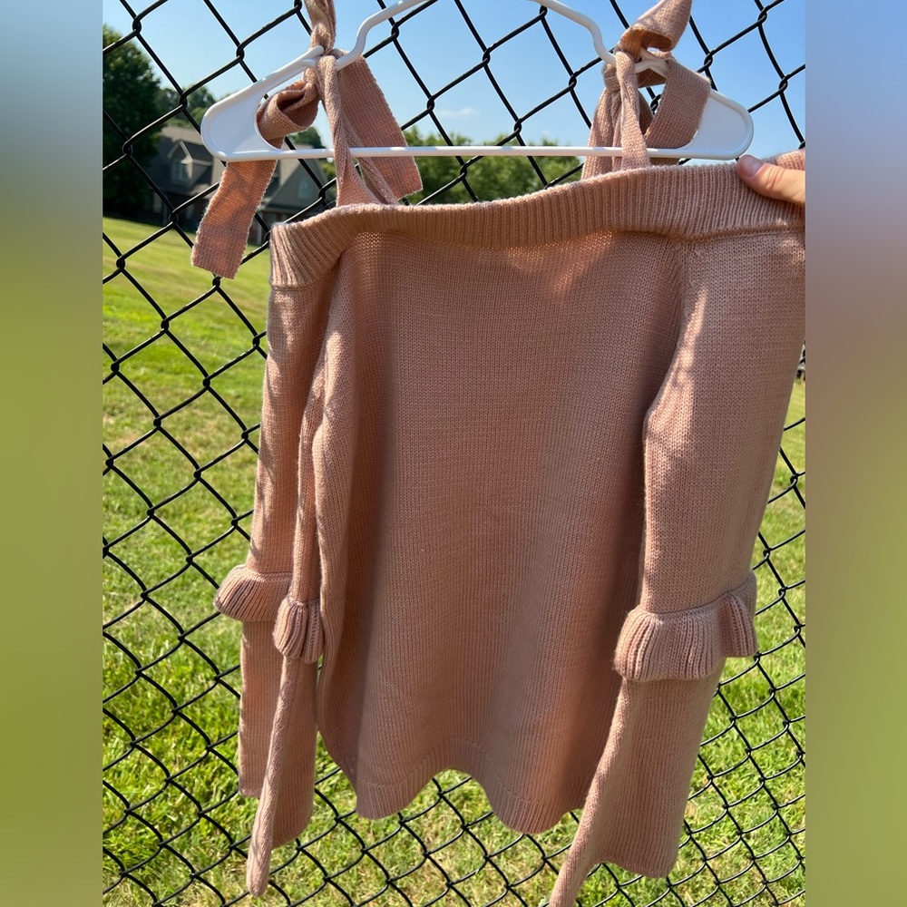 Off the shoulder salmon colored sweater in size medium with bow ties.